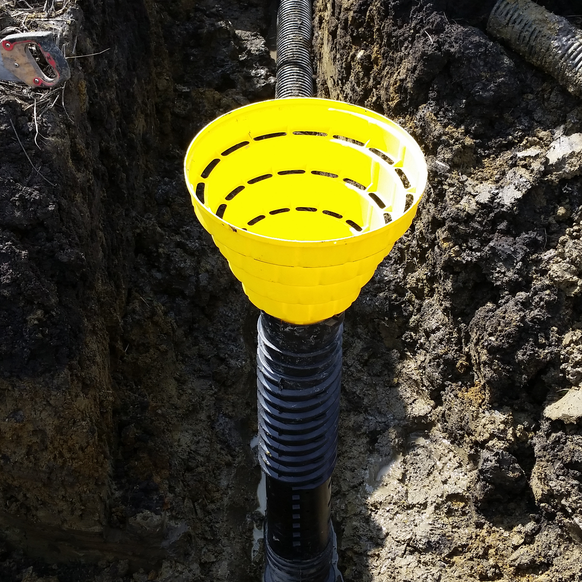 Adjustable Inlet installed in the field, as an example application. The inlet is installed in a Tee section, with a Quick Drain Lo Profile as the surface inlet.
